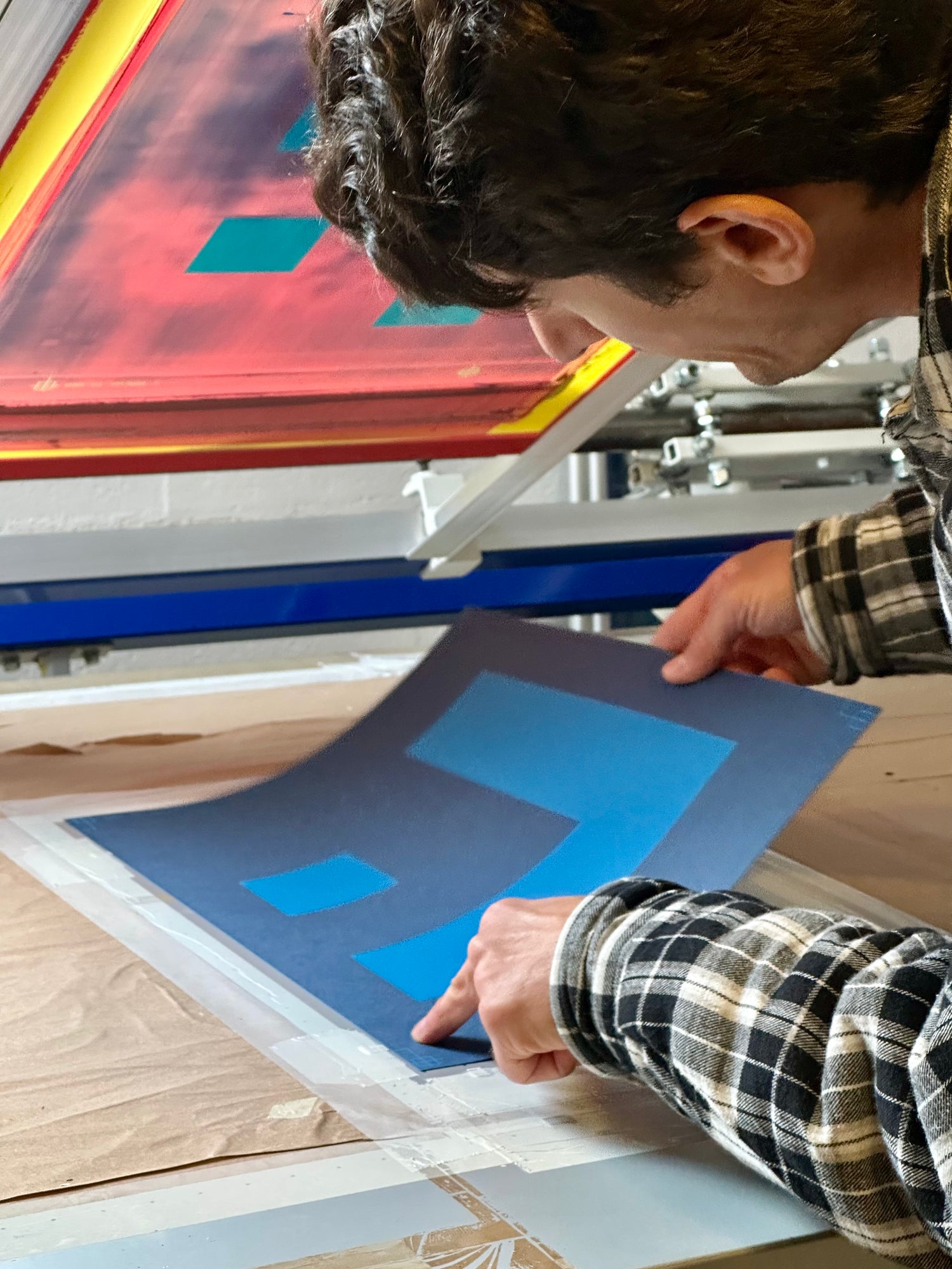 Silkscreen printing in perfect registration — multiple color layers aligned precisely by hand at Murotopia Studio.