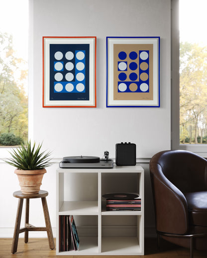 Two framed abstract prints displayed together in a contemporary room